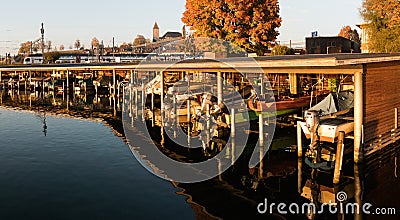 Rapperswil, SG / Switzerland - November 5, 2018: SBB train enters Rapperswil train station behind harbor in evening light bringing Editorial Stock Photo