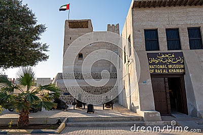 Ras al Khaimah Museum historical tourist location entrance, flag, and cannons on a sunny day Editorial Stock Photo