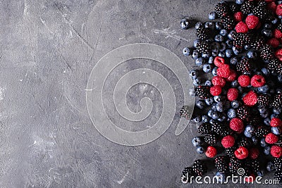 Raspberries, blackberries, blueberries a gray abstract background. Stock Photo