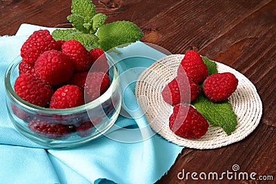 Raspberries in a glass container and on a string circle Stock Photo