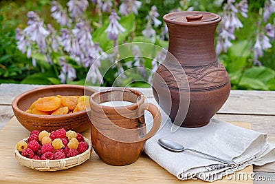 Raspberry apricots milk in pottery. Rustic. Stock Photo