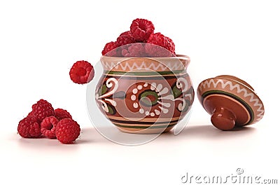 raspberry in clay pot isolated on white, berry falling Stock Photo