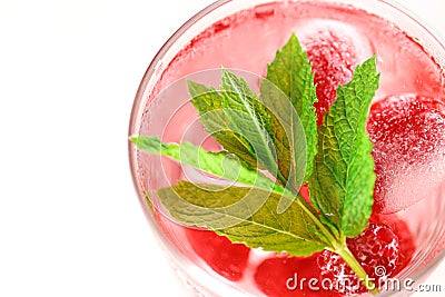 Raspberry cocktail.raspberry pink drink.Ice cubes with raspberries in a glass with water, berries and raspberry leaves Stock Photo