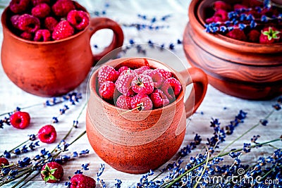 raspberry composition in pottery with dry lavender rustic backgr Stock Photo