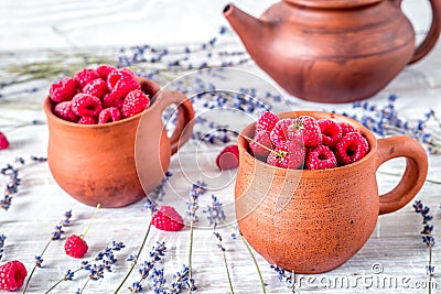 raspberry composition in pottery with dry lavender rustic background Stock Photo