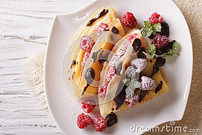 Raspberry crepes with chocolate and mint closeup. horizontal top Stock Photo