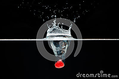 Raspberry falls deeply under water with a big splash. Stock Photo