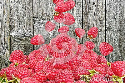 Raspberry falls to the lot on a wooden background Stock Photo