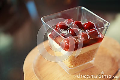 Raspberry jam sweet dessert, cheesecake, trifle, mousse snack in a cocktail glass on a wooden tray background. Festive layered Stock Photo