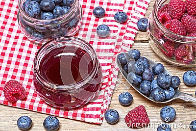 Raspberry marmalade and the fresh raspberries and blueberries Stock Photo