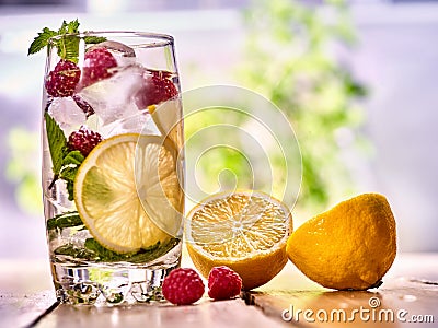 Raspberry mojito with cubes lemon ice glass. Outdoor. Stock Photo
