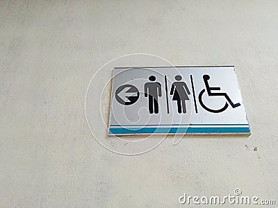 Toilet sign disable wrong direction Stock Photo
