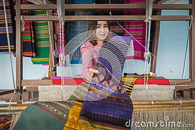Local Thai weaver crafting traditional silk on a loom Editorial Stock Photo