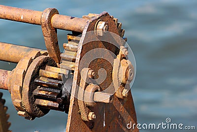 Ratchet and pawl mechanism of old rusty winch on a pier Stock Photo