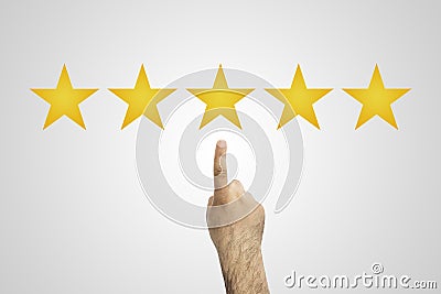 Rate. 5 stars. Hand click on five yellow stars to increase rating. Customer reviews, rating, classification concept. Stock Photo