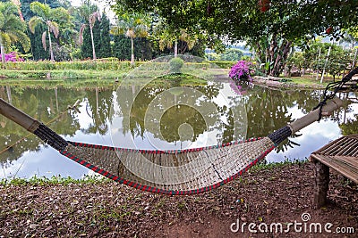 Rattan bamboo hammock hanging on tree Stock Photo