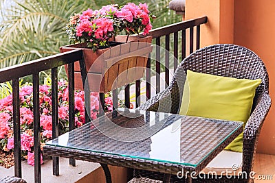 Ratten table and armchair with pillows on the balcony Stock Photo