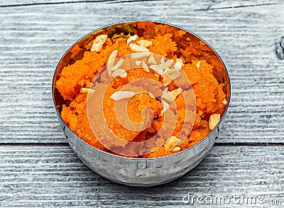 Rava kesari halwa sweet with nuts served in dish isolated on wooden table top view of indian dessert food Stock Photo