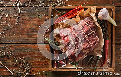 Raw aged prime black angus beef in craft papper on rustic wood Stock Photo