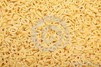 Raw alphabet soup pasta Stock Photo