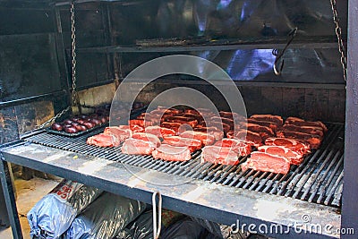 Raw argentine barbecue steaks and blood sausages on typical parrilla argentine barbecue Stock Photo