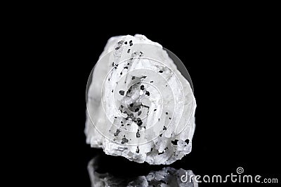 Raw barite or barium mineral stone with tourmaline or schorl in front of black background Stock Photo