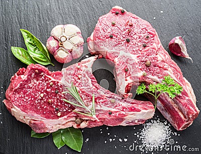 Raw beaf steaks with spices. Stock Photo
