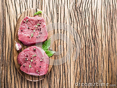 Raw beaf steaks with spices. Stock Photo
