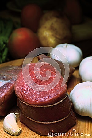 Raw beef and garlic on blur background Stock Photo