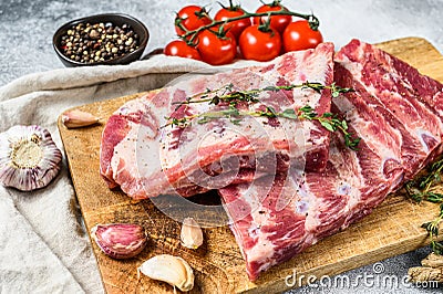 Raw beef ribs with rosemary, pepper and garlic. Gray background. Top view Stock Photo