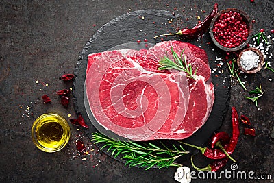Raw beef steak on black background with cooking ingredients. Fresh beef meat Stock Photo
