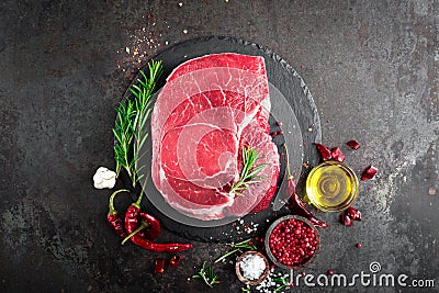 Raw beef steak on black background with cooking ingredients. Fresh beef meat Stock Photo