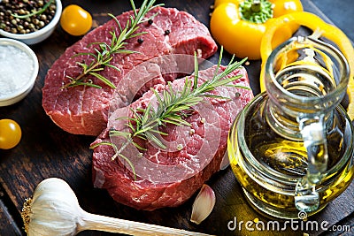 Raw beef steak on a dark wooden table Stock Photo