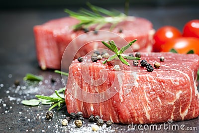 Raw Beef Steaks with spices and Rosemary over Slate Stock Photo