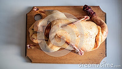 Raw bird carcass on a cutting board Stock Photo