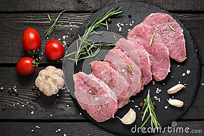 Raw boneless pork chops, vegetables, herbs and spices Stock Photo