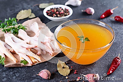 Raw Chicken Feet for Making Nutritional Bone Broth on dark background Stock Photo