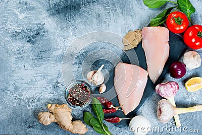 Raw chicken fillet on cutting board with spices and herbs. Stock Photo