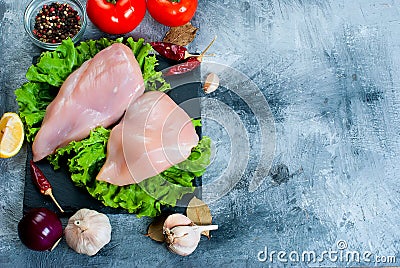 Raw chicken fillet on cutting board with spices and herbs. Stock Photo