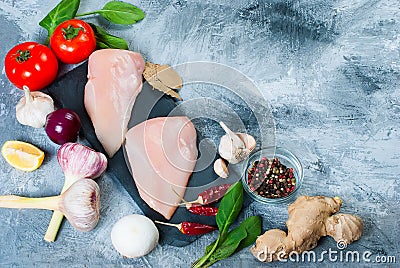 Raw chicken fillet on cutting board with spices and herbs. Stock Photo