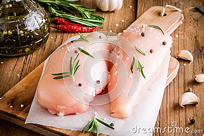 Raw chicken fillet with garlic, pepper, olive oil and rosemary Stock Photo