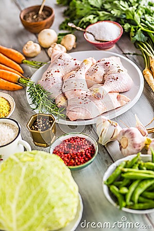 Raw chicken legs with assortment spices and vegetables Stock Photo