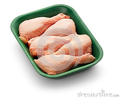 Raw chicken legs in a green tray over white background Stock Photo