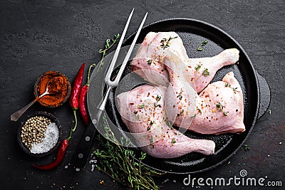 Raw chicken quarters, legs in a pan on a dark background Stock Photo