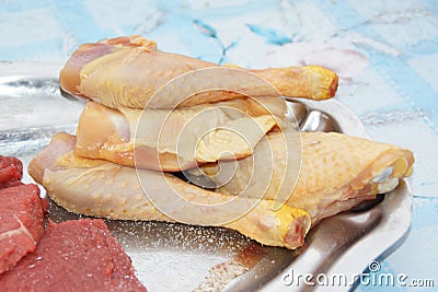 Raw chicken rammers in a dish Stock Photo