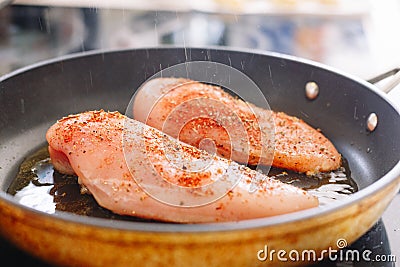 Raw chicken steaks fried in a pan Stock Photo