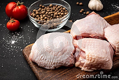 Raw chicken thigh on black background Stock Photo