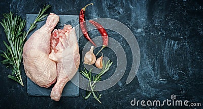 Raw chicken thigh on black stone plate. Stock Photo