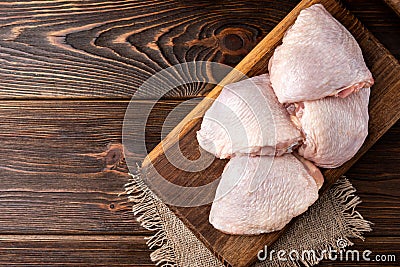 Raw chicken thigh on wooden. Stock Photo