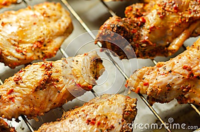 Raw chicken wings with a rendang style rub made with chilli and garlic on the grill tray Stock Photo